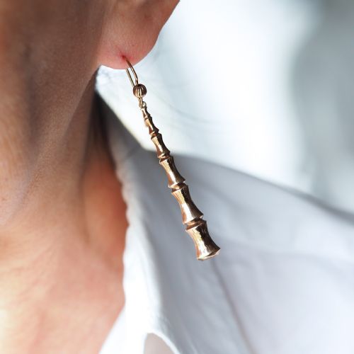 fig 6. A pair of 9ct yellow gold drop earrings designed with stacked bamboo node motifs hanging from shepherd hook ear wires.