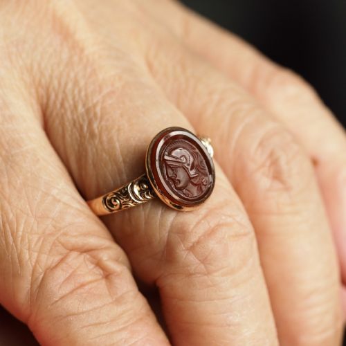fig 8. A Georgian gold ring featuring an oval reddish-brown carnelian stone engraved with the profile profile of a helmeted Roman soldier.