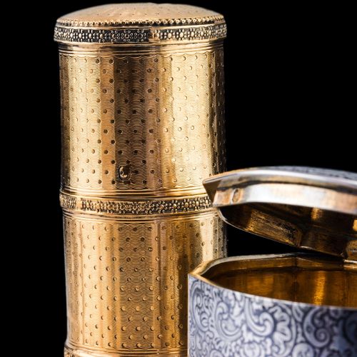fig 4. A small cylindrical French silver gilt etui featuring intricate engine-turned guilloche wave patterns and textured borders.