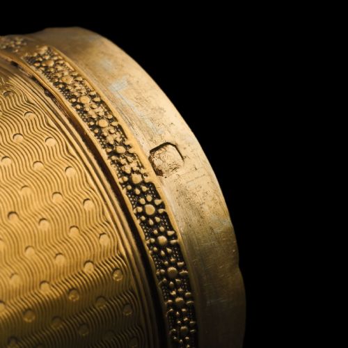 fig 5. A small cylindrical French silver gilt etui featuring intricate engine-turned guilloche wave patterns and textured borders.