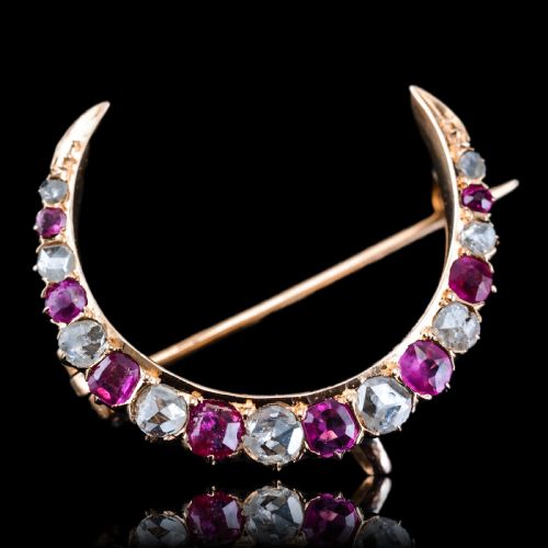 fig 1. An 18K gold Victorian crescent moon brooch set with alternating cushion-cut rubies and old-cut diamonds.