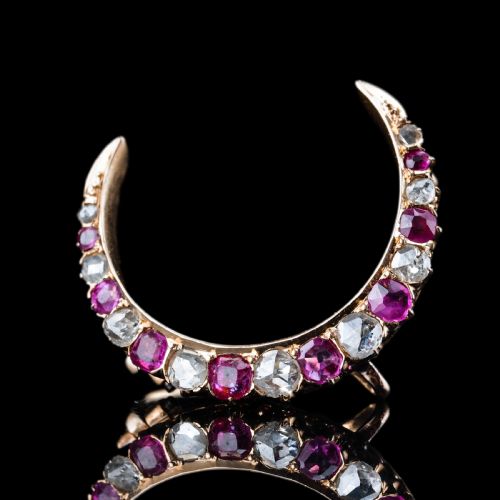 fig 4. An 18K gold Victorian crescent moon brooch set with alternating cushion-cut rubies and old-cut diamonds.