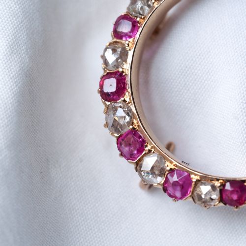 fig 5. An 18K gold Victorian crescent moon brooch set with alternating cushion-cut rubies and old-cut diamonds.
