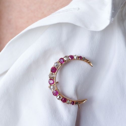 fig 6. An 18K gold Victorian crescent moon brooch set with alternating cushion-cut rubies and old-cut diamonds.