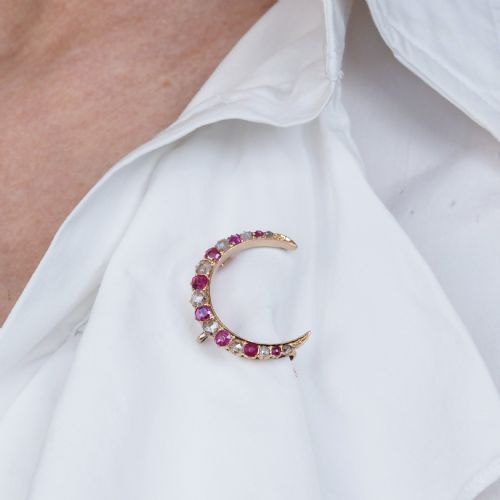 fig 7. An 18K gold Victorian crescent moon brooch set with alternating cushion-cut rubies and old-cut diamonds.