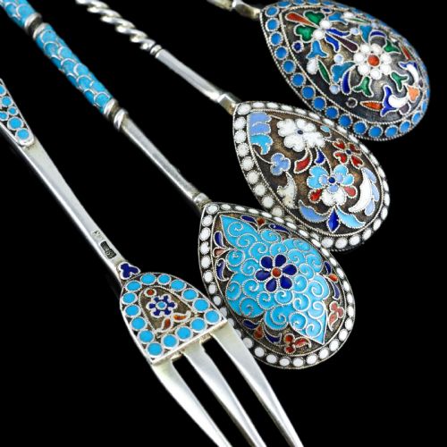 fig 1. A four-piece set of late 19th-century Russian silver and cloisonne enamel cutlery featuring three spoons and a fork with turquoise blue, white, and red floral motifs.