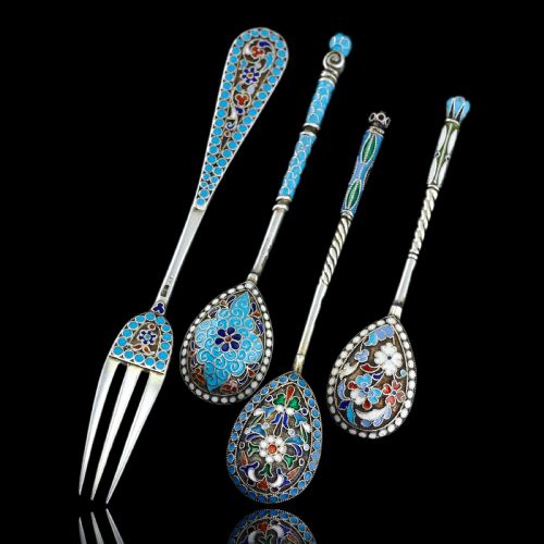 fig 5. A four-piece set of late 19th-century Russian silver and cloisonne enamel cutlery featuring three spoons and a fork with turquoise blue, white, and red floral motifs.