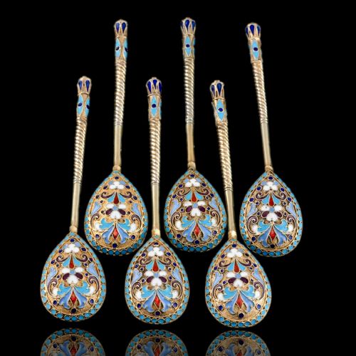 fig 3. Set of six antique Russian silver gilt spoons featuring blue, red, and white cloisonne enamel scrollwork on the backs of the teardrop-shaped bowls.