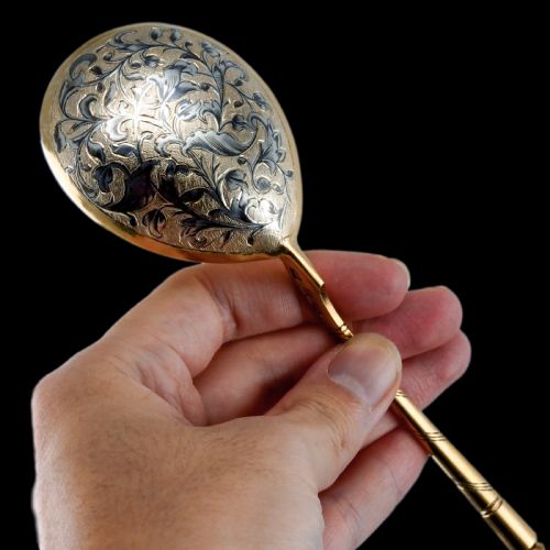 fig 6. An antique Russian silver-gilt serving spoon featuring intricate black niello foliate engraving across the back of the oval bowl and a turned stem.