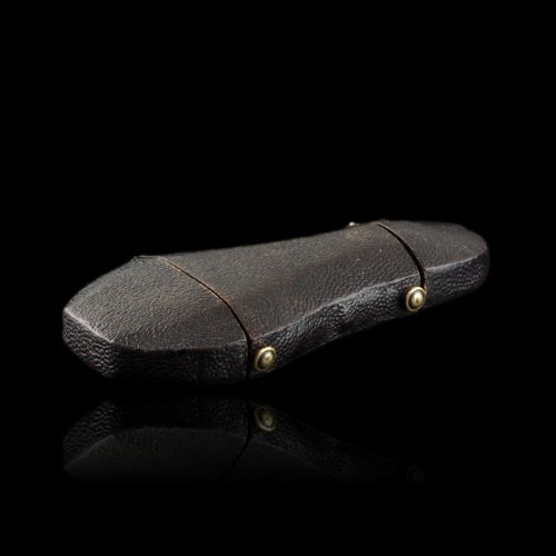 fig 4. A seventeenth-century teardrop-shaped silver gilt scent flask engraved with a coronet and crest, positioned alongside its dark leather case.