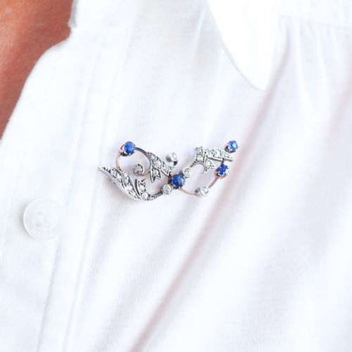 fig 5. An antique Victorian foliate scroll brooch crafted in gold and silver, set with circular blue sapphires and accent diamonds.