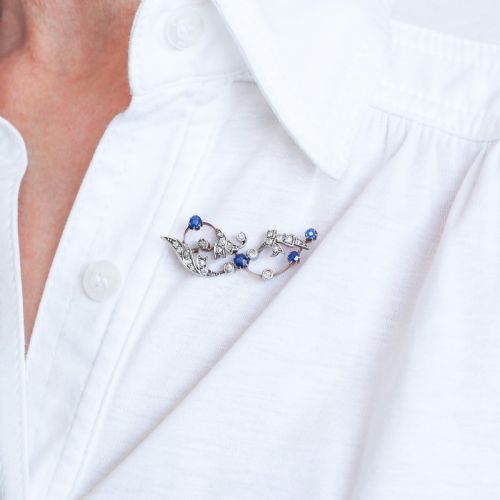 fig 7. An antique Victorian foliate scroll brooch crafted in gold and silver, set with circular blue sapphires and accent diamonds.