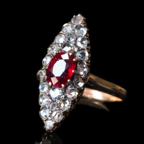 fig 4. An antique late-nineteenth-century French 18k gold navette cluster ring featuring a central oval red ruby surrounded by multiple rose-cut diamonds.
