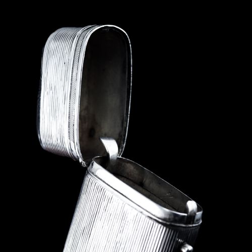 fig 1. A 19th-century Dutch solid silver cigar case featuring a reeded linear texture and rounded ends with fan-shaped engraving.