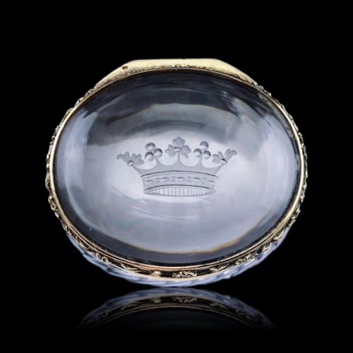 fig 2. An oval cut crystal box featuring a gilt silver rim and a transparent glass lid etched with a nobility coronet crest.