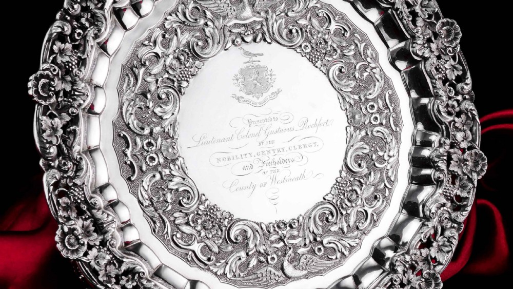 A circular Georgian sterling silver salver featuring an intricately detailed cast floral border and central inscription engraving. View III