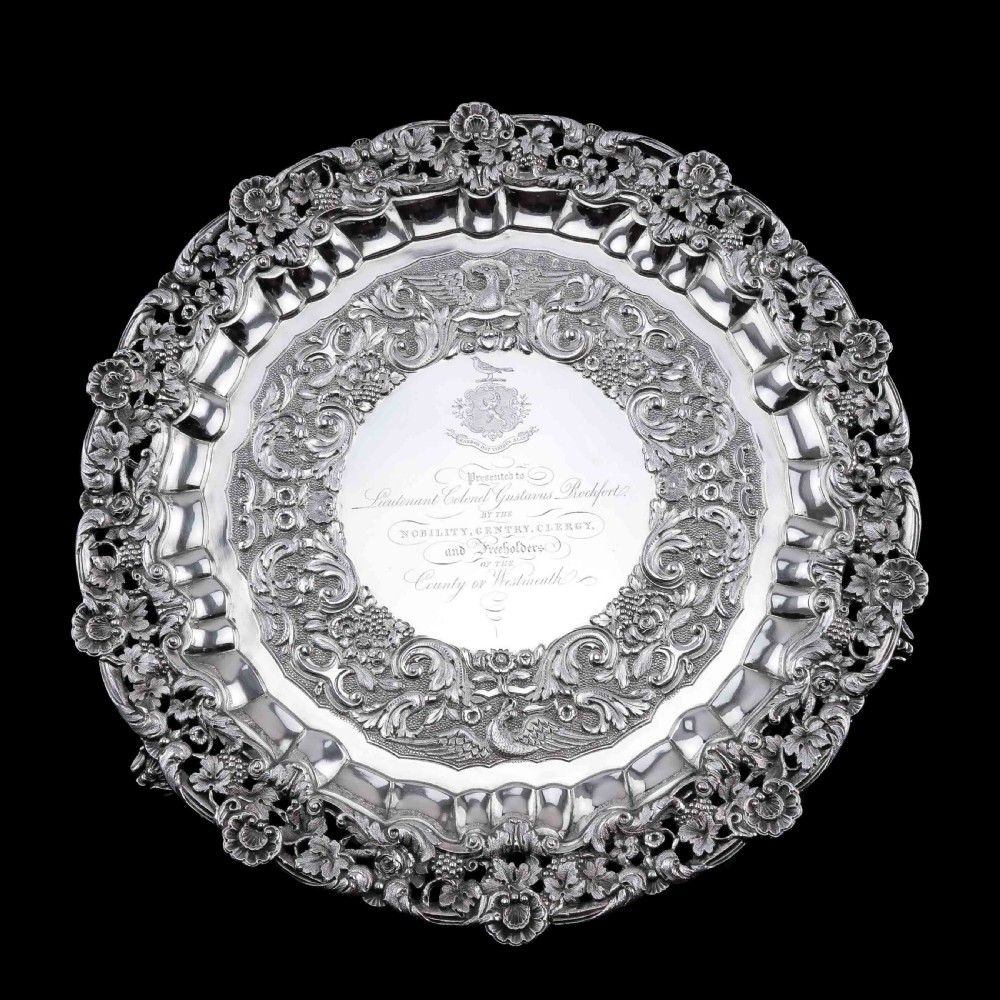 A circular Georgian sterling silver salver featuring an intricately detailed cast floral border and central inscription engraving. View VII