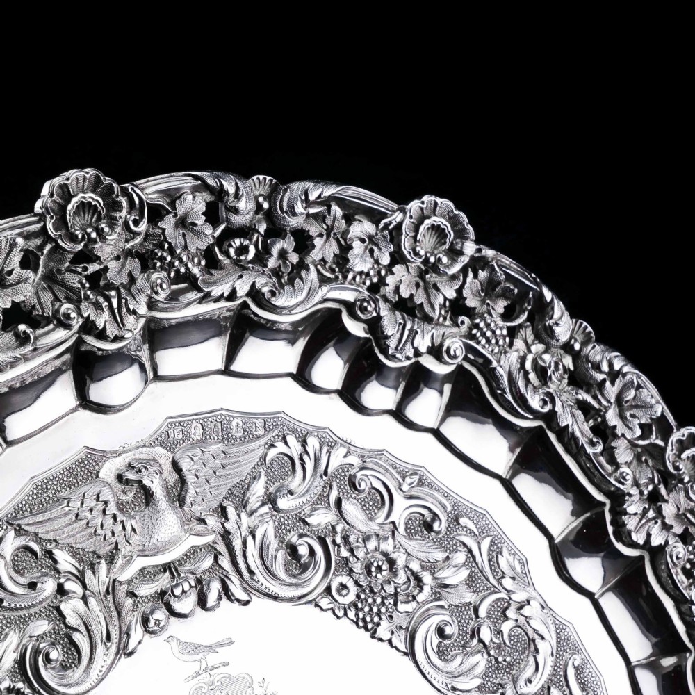 A circular Georgian sterling silver salver featuring an intricately detailed cast floral border and central inscription engraving. View XI