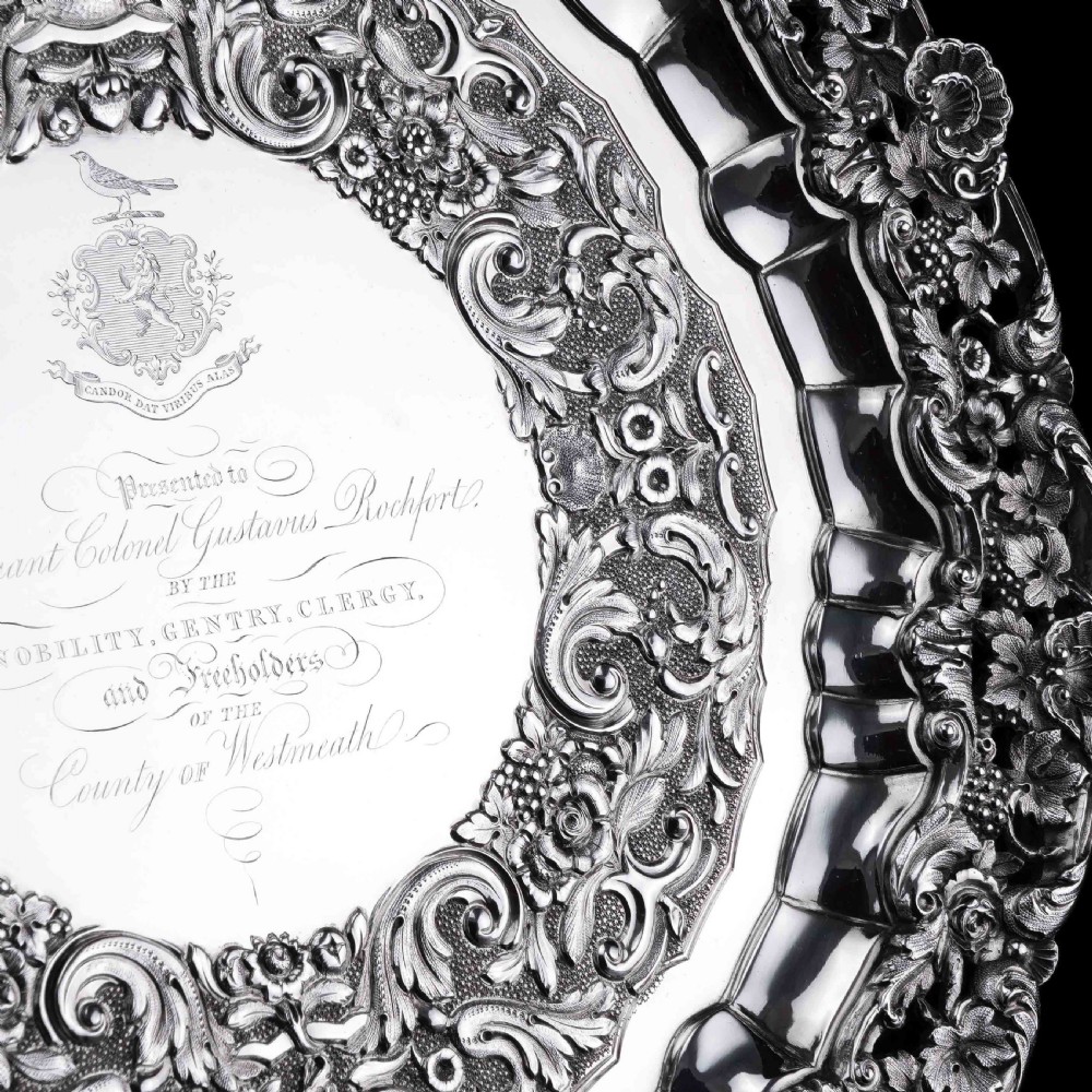 A circular Georgian sterling silver salver featuring an intricately detailed cast floral border and central inscription engraving. View XII