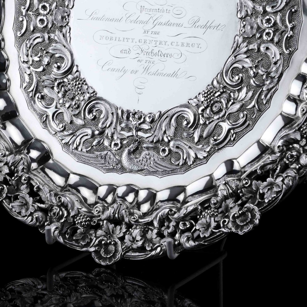 A circular Georgian sterling silver salver featuring an intricately detailed cast floral border and central inscription engraving. View XIV