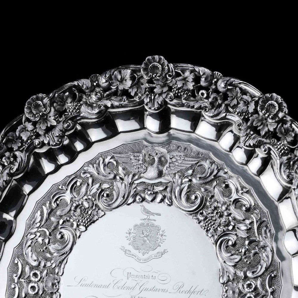 A circular Georgian sterling silver salver featuring an intricately detailed cast floral border and central inscription engraving. View XV