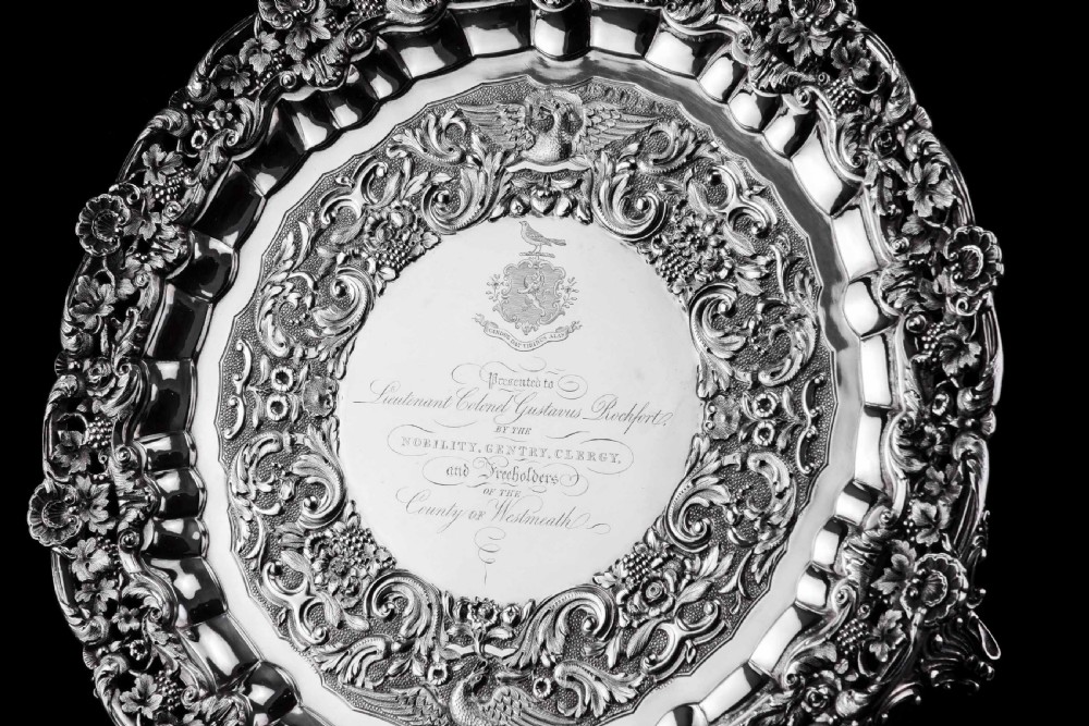 A circular Georgian sterling silver salver featuring an intricately detailed cast floral border and central inscription engraving. View XVI