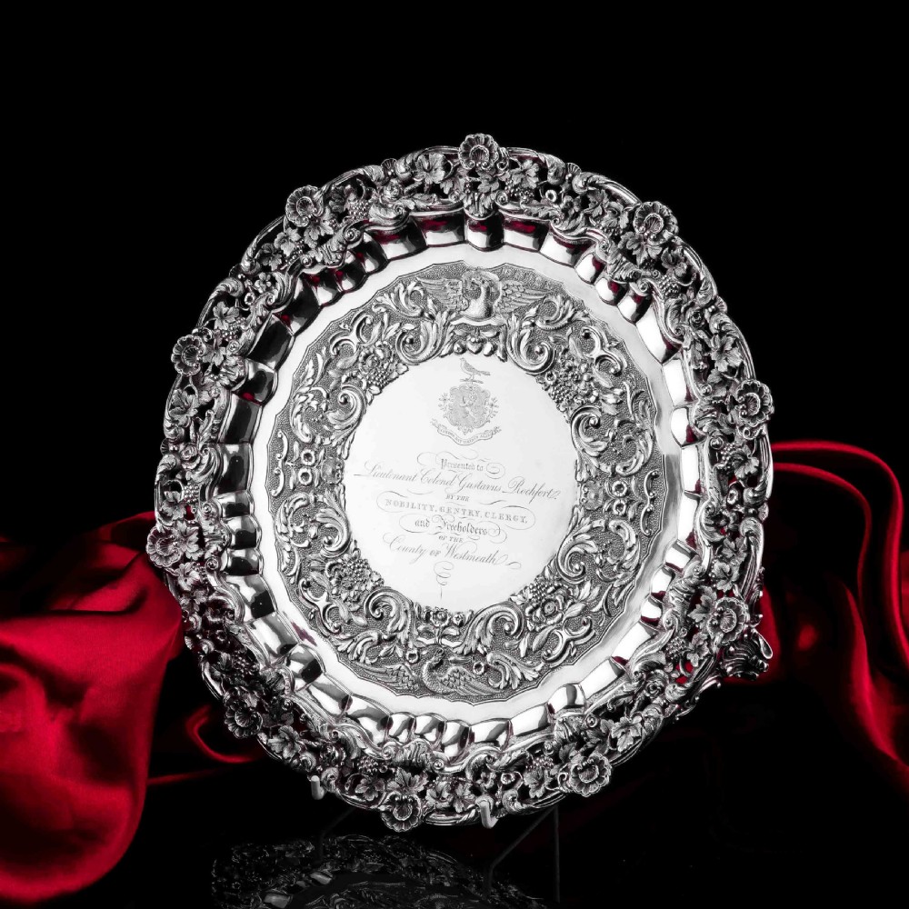 A circular Georgian sterling silver salver featuring an intricately detailed cast floral border and central inscription engraving. View XIX