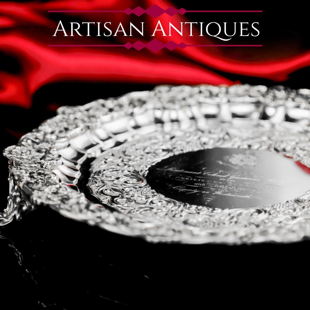 A circular Georgian sterling silver salver featuring an intricately detailed cast floral border and central inscription engraving. View XXIV