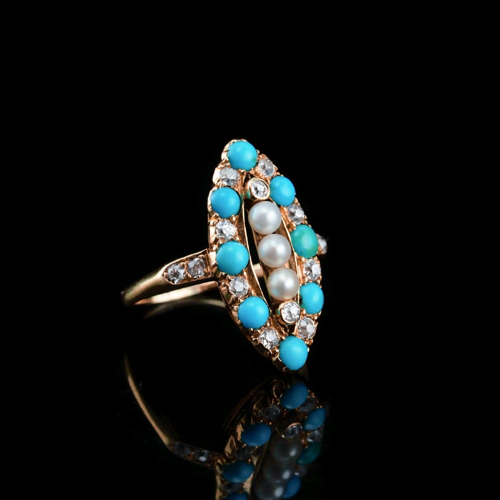 An antique Victorian 18ct yellow gold navette ring featuring three central pearls flanked by turquoise cabochons and old-cut diamonds. View IX