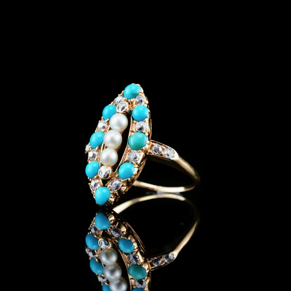 An antique Victorian 18ct yellow gold navette ring featuring three central pearls flanked by turquoise cabochons and old-cut diamonds. View XI