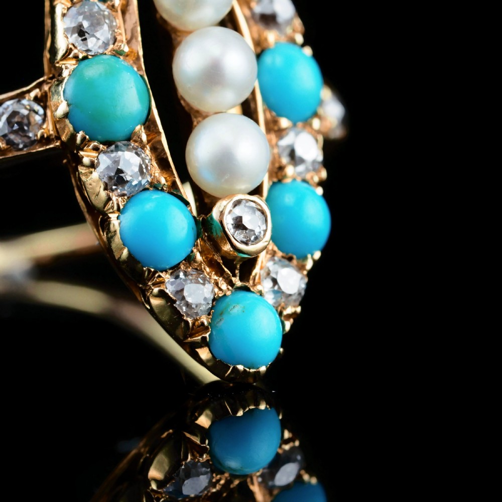 An antique Victorian 18ct yellow gold navette ring featuring three central pearls flanked by turquoise cabochons and old-cut diamonds. View XII