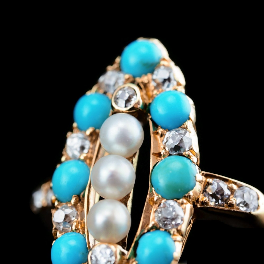 An antique Victorian 18ct yellow gold navette ring featuring three central pearls flanked by turquoise cabochons and old-cut diamonds. View XIII