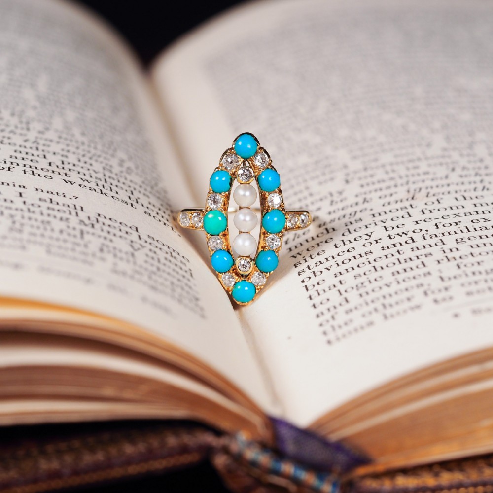 An antique Victorian 18ct yellow gold navette ring featuring three central pearls flanked by turquoise cabochons and old-cut diamonds. View XIV