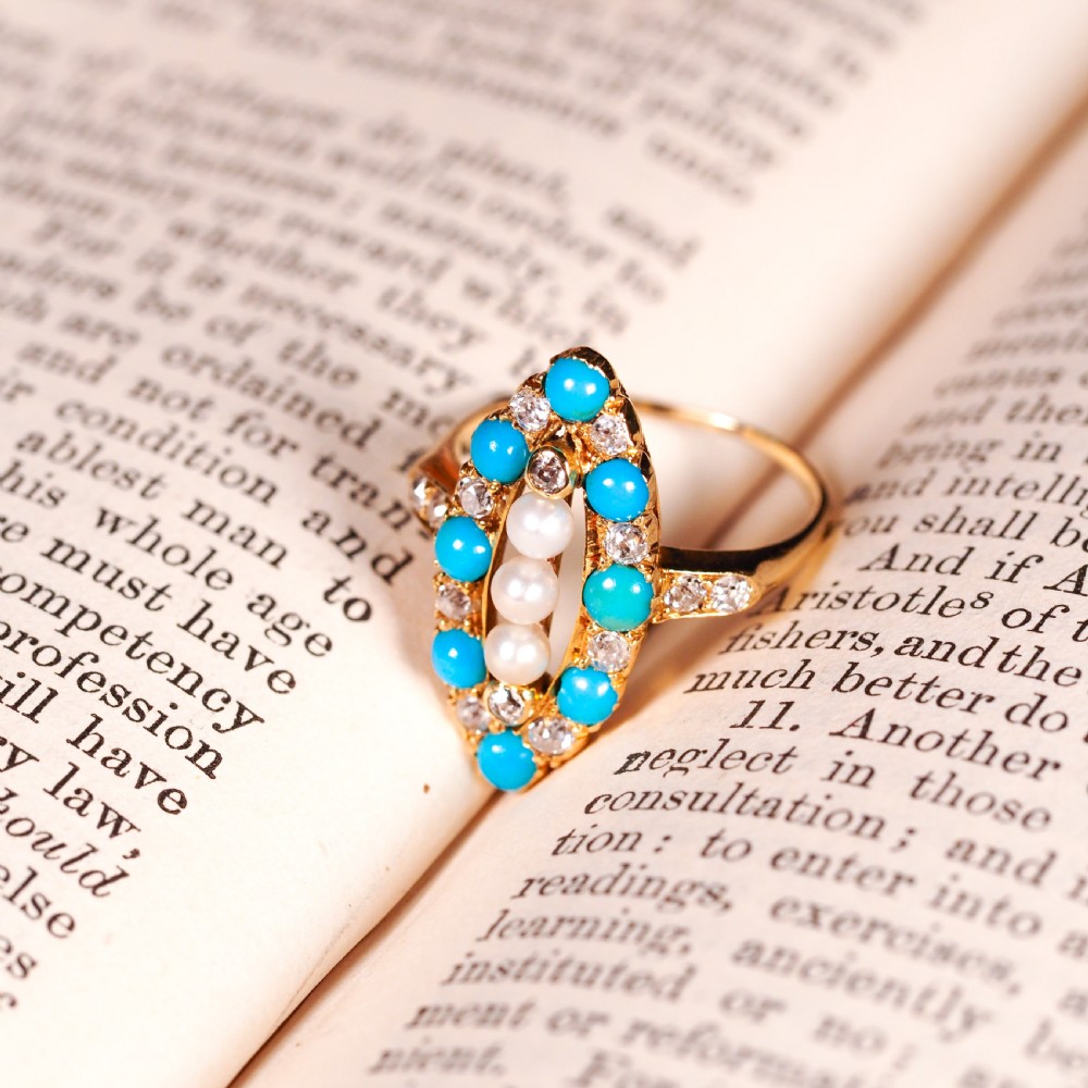 An antique Victorian 18ct yellow gold navette ring featuring three central pearls flanked by turquoise cabochons and old-cut diamonds. View XV