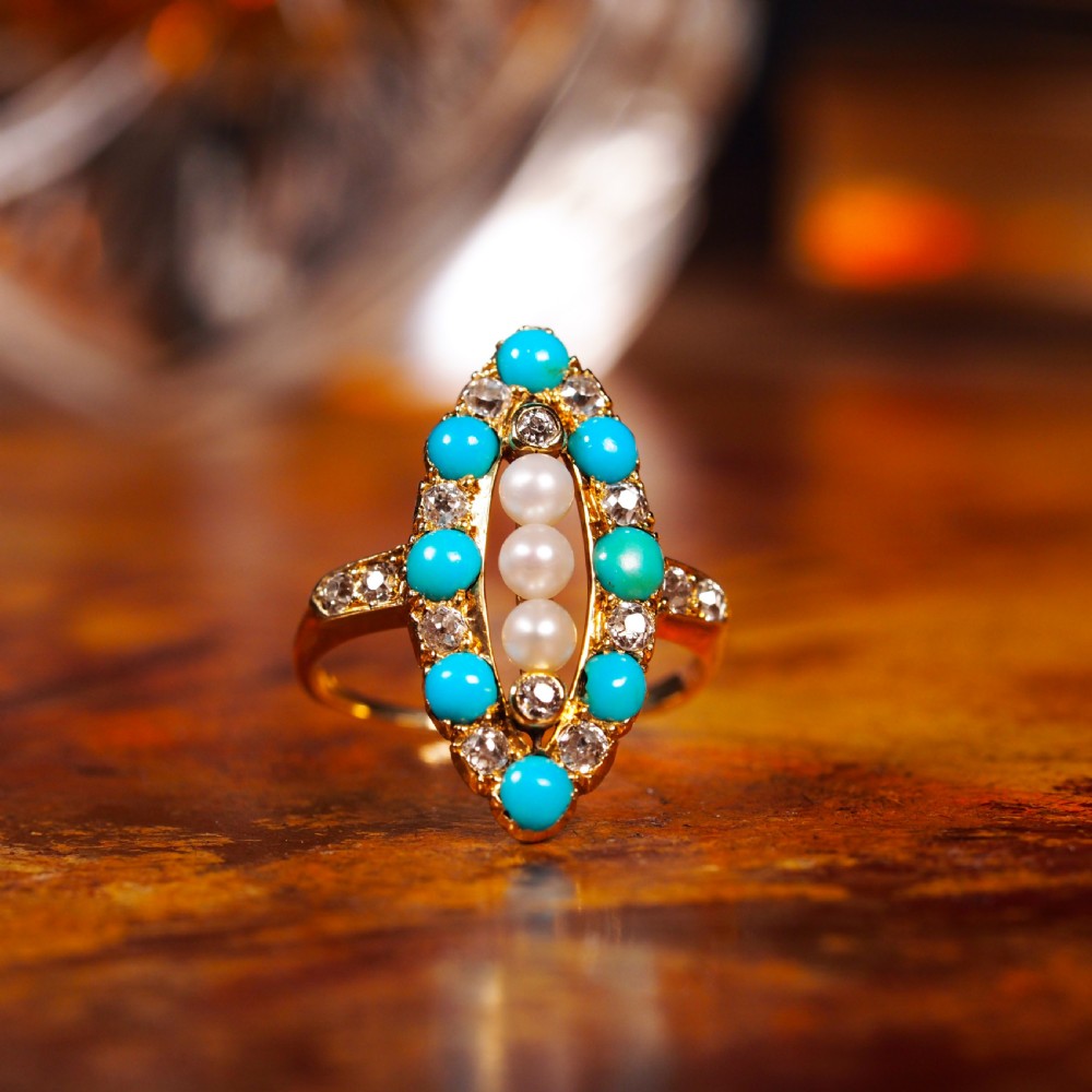 An antique Victorian 18ct yellow gold navette ring featuring three central pearls flanked by turquoise cabochons and old-cut diamonds. View XVII