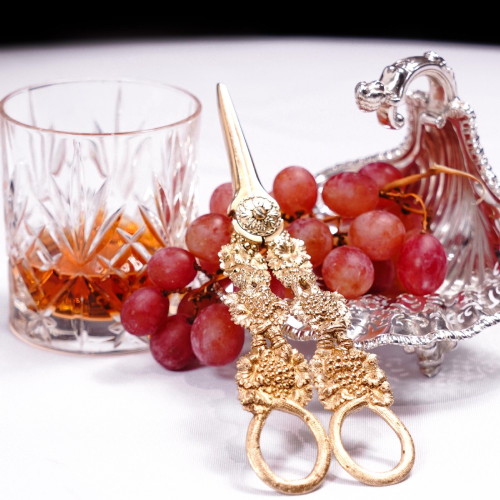 A pair of Georgian solid silver gilt grape shears featuring cast grapevine handle motifs. View II