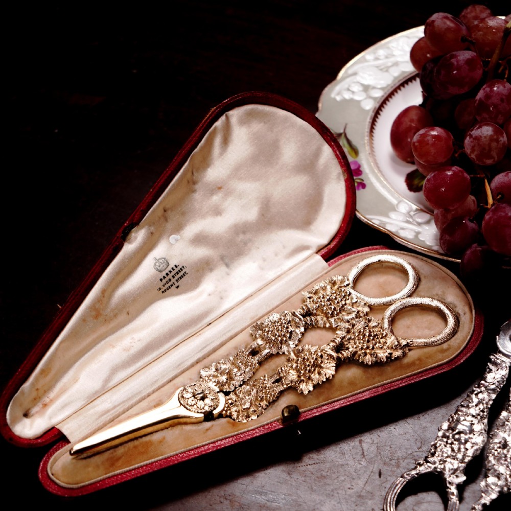 A pair of Georgian solid silver gilt grape shears featuring cast grapevine handle motifs. View VI