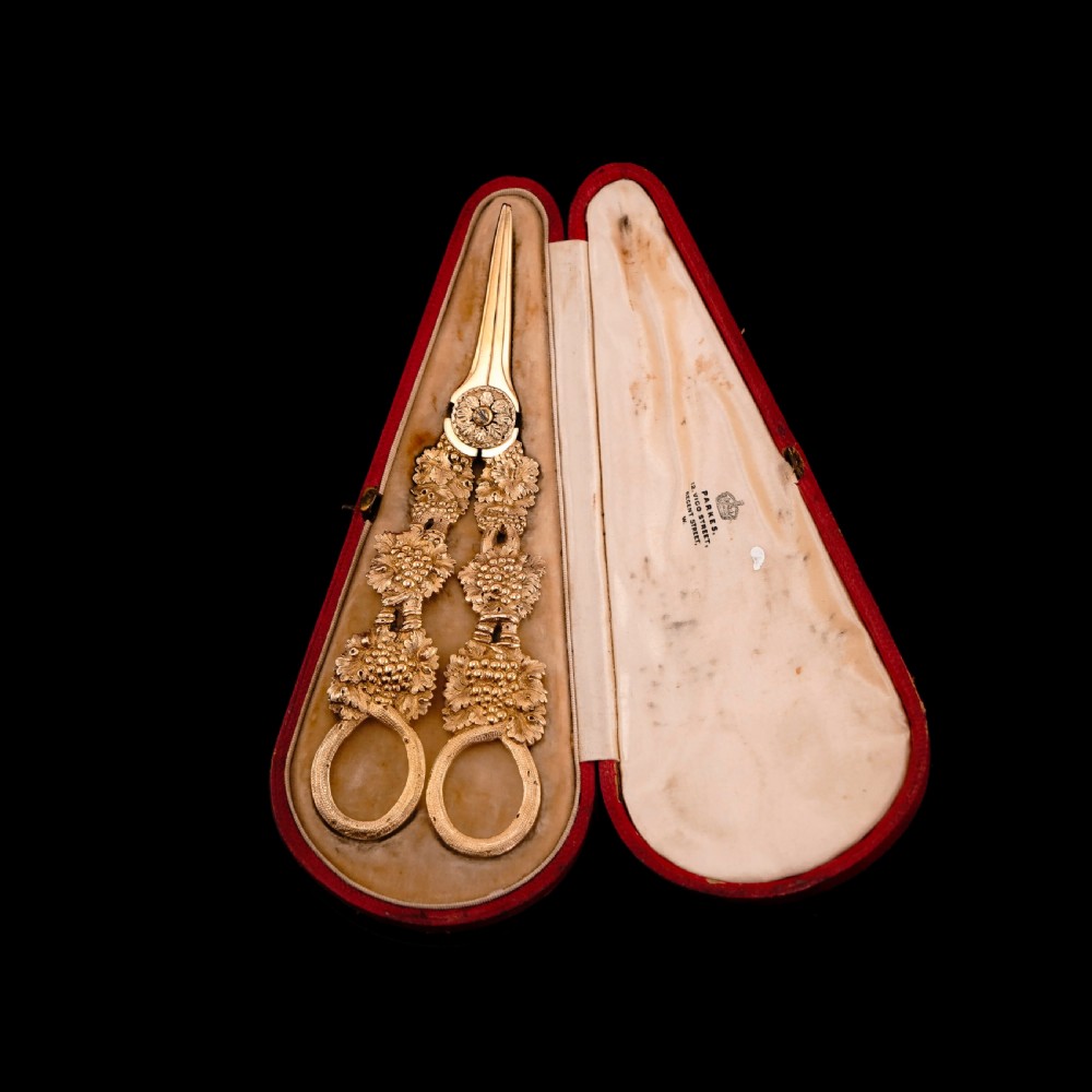 A pair of Georgian solid silver gilt grape shears featuring cast grapevine handle motifs. View X
