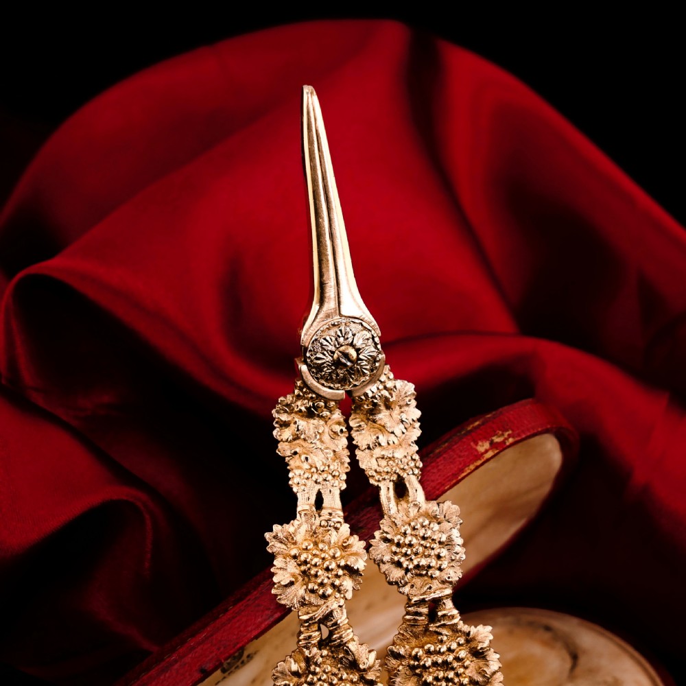 A pair of Georgian solid silver gilt grape shears featuring cast grapevine handle motifs. View XI
