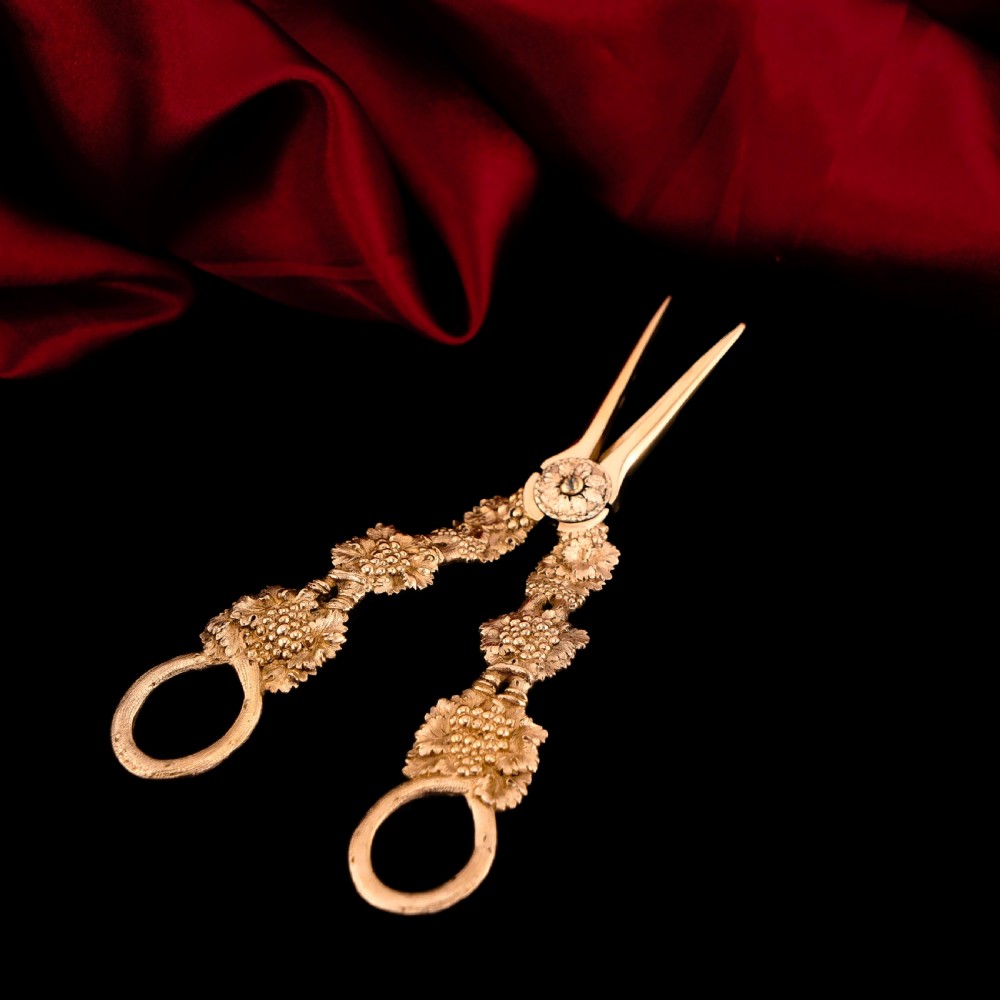 A pair of Georgian solid silver gilt grape shears featuring cast grapevine handle motifs. View XV