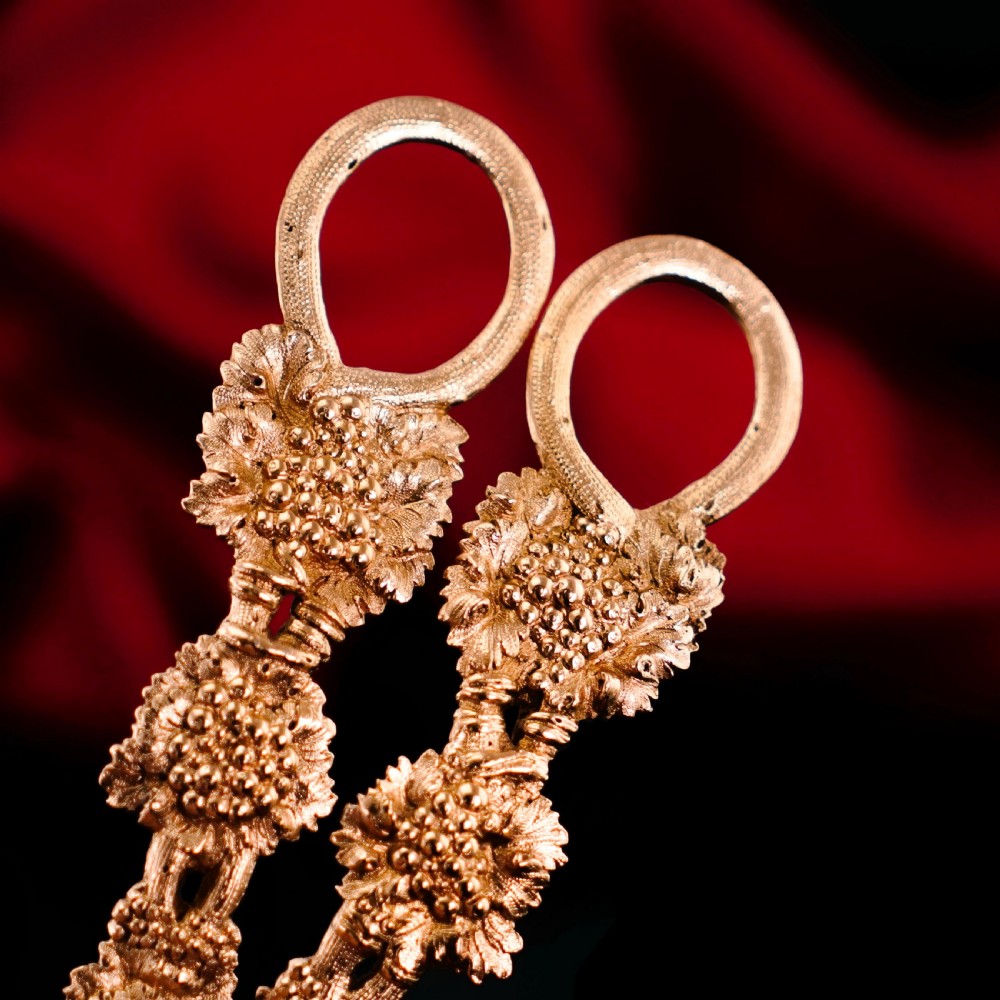 A pair of Georgian solid silver gilt grape shears featuring cast grapevine handle motifs. View XVI