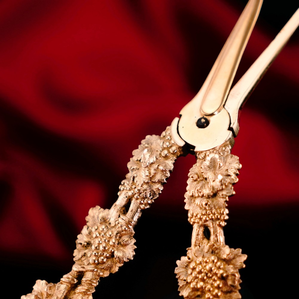 A pair of Georgian solid silver gilt grape shears featuring cast grapevine handle motifs. View XIX