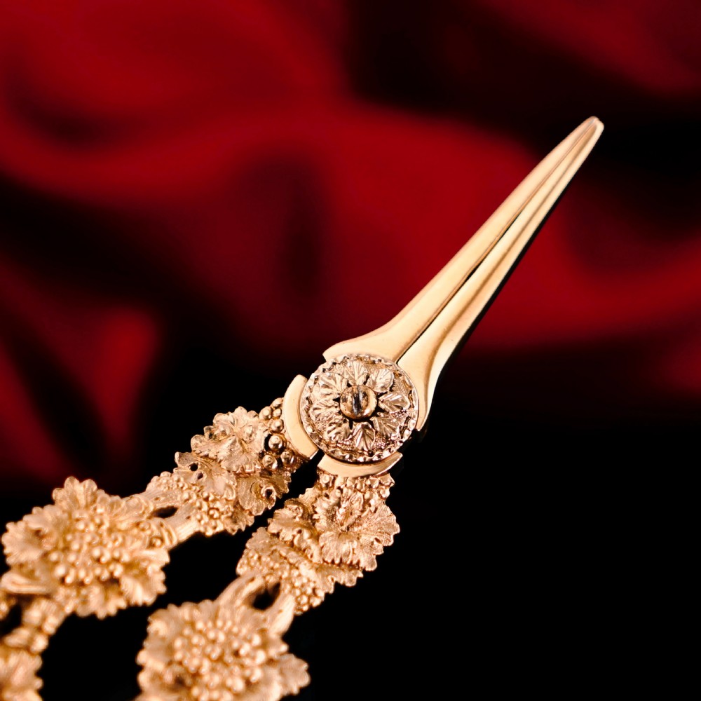 A pair of Georgian solid silver gilt grape shears featuring cast grapevine handle motifs. View XX