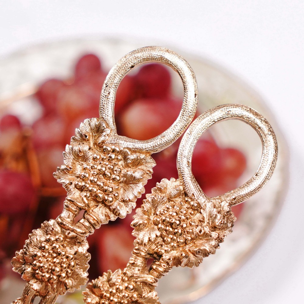 A pair of Georgian solid silver gilt grape shears featuring cast grapevine handle motifs. View XXIII