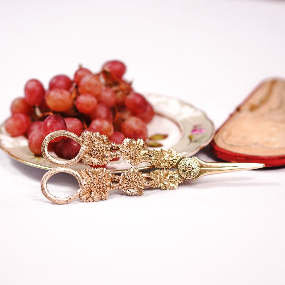 A pair of Georgian solid silver gilt grape shears featuring cast grapevine handle motifs. View XXIV