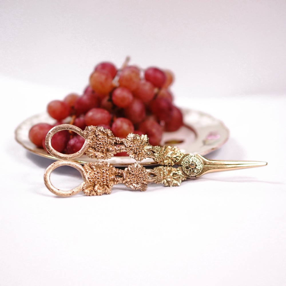 A pair of Georgian solid silver gilt grape shears featuring cast grapevine handle motifs. View XXV