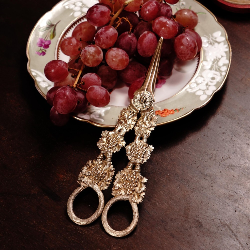 A pair of Georgian solid silver gilt grape shears featuring cast grapevine handle motifs. View XXVIII