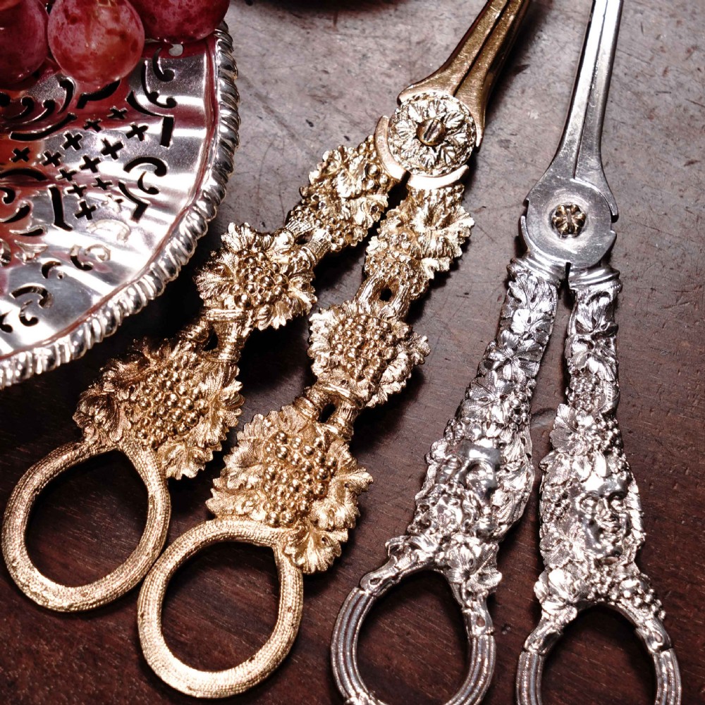 A pair of Georgian solid silver gilt grape shears featuring cast grapevine handle motifs. View XXIX