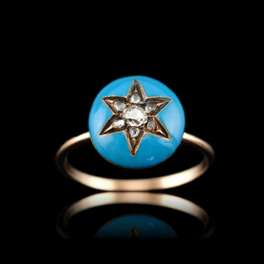 A 9ct yellow gold ring featuring a bright blue enamel dome set with a central six-pointed diamond star motif.