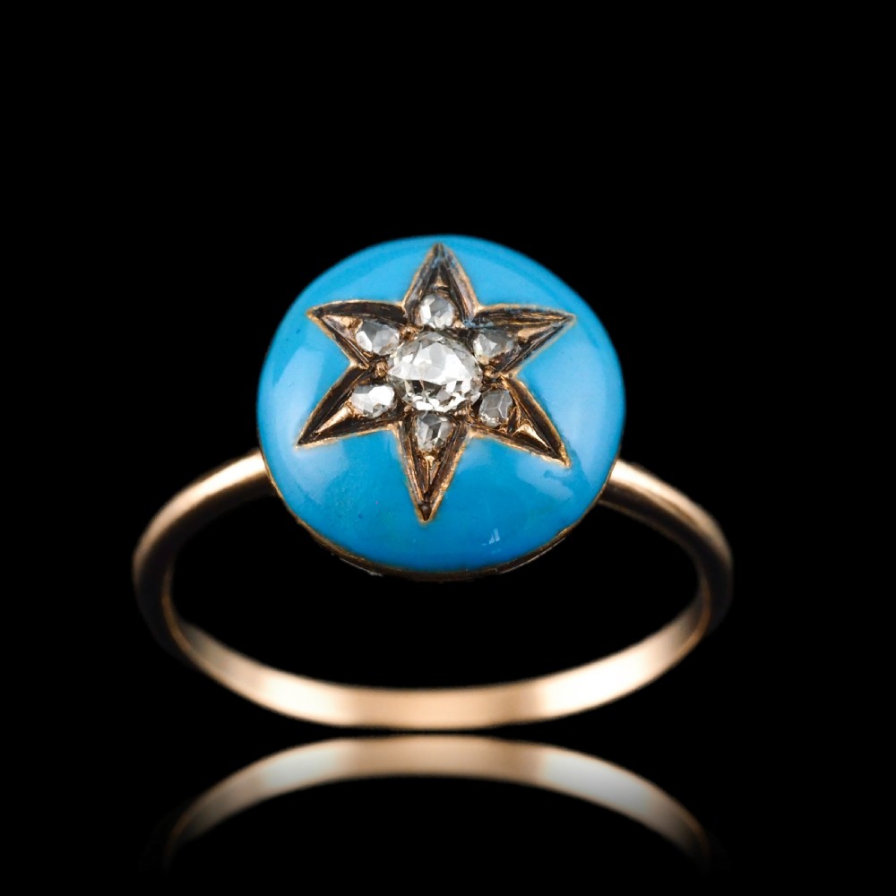 A 9ct yellow gold ring featuring a bright blue enamel dome set with a central six-pointed diamond star motif. View V